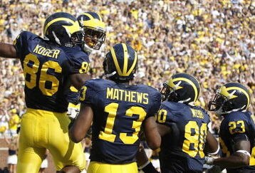 ANN ARBOR, MI - SEPTEMBER 05: Kevin Koger #86 of the Michigan Wolverines celebrates a second quarter touchdown catch with Greg Mathews #13, Martell Webb #80 and Carlos Brown #23 while playing the Western Michigan Broncos on September 5, 2009 at Michigan Stadium in Ann Arbor, Michigan.  (Photo by Gregory Shamus/Getty Images)