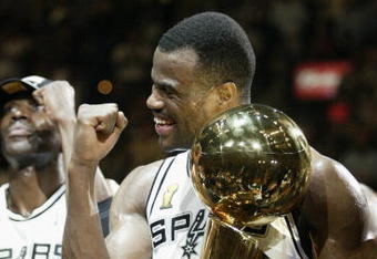 SAN ANTONIO, TX - JUNE 15:  David Robinson #50 and the San Antonio Spurs celebrate after winning Game six of the 2003 NBA Finals against the New Jersey Nets on June 15, 2003 at the SBC Center in San Antonio, Texas.  The Spurs won 88-77 and defeated the Nets to win the NBA Championship.  NOTE TO USER: User expressly acknowledges and agrees that, by downloading and/or using this Photograph, User is consenting to the terms and conditions of the Getty Images License Agreement.  (Photo by Jed Jacobsohn/Getty Images)