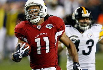 TAMPA, FL - FEBRUARY 01:  Wide receiver Larry Fitzgerald #11 of the Arizona Cardinals scores a 64-yard touchdown reception in the fourth quarter against Troy Polamalu #43 of the Pittsburgh Steelers during Super Bowl XLIII on February 1, 2009 at Raymond James Stadium in Tampa, Florida.  (Photo by Kevin C. Cox/Getty Images)