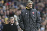 BLACKBURN, UNITED KINGDOM - FEBRUARY 25: Arsene Wenger the manager of Arsenal look and Mark Hughes the manager of Blackburn Rovers look on during the Barclays Premiership match between Blackburn Rovers and Arsenal at Ewood Park on February 25, 2006 in Blackburn, England. (Photo by Alex Livesey/Getty Images)