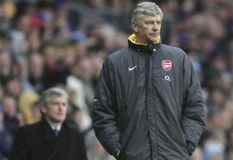 BLACKBURN, UNITED KINGDOM - FEBRUARY 25:  Arsene Wenger the manager of Arsenal look and Mark Hughes the manager of Blackburn Rovers look on during the Barclays Premiership match between Blackburn Rovers and Arsenal at Ewood Park on February 25, 2006 in Blackburn, England.  (Photo by Alex Livesey/Getty Images)