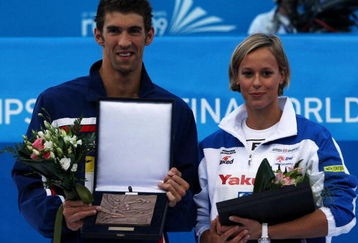 ROME - AUGUST 02:  Michael Phelps of the United States and Federica Pellegrini of Italy receive an award after the 13th FINA World Championships at the Stadio del Nuoto on August 2, 2009 in Rome, Italy.  (Photo by Quinn Rooney/Getty Images)