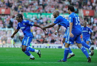 STOKE ON TRENT, ENGLAND - SEPTEMBER 12:  Florent Malouda of Chelsea celebrates scoring the winning goal with his team mates during the Barclays Premier League match between Stoke City and Chelsea at the Britannia Stadium on September 12, 2009 in Stoke on Trent, England.  (Photo by Michael Regan/Getty Images)