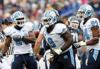 EAST HARTFORD, CT - SEPTEMBER 12:  Bruce Carter #54, Marvin Austin #9 and Michael McAdoo #94 of the North Carolinia Tar Heels celebrate a safety that was awarded to the Tar Heels after the Connecticut Huskies were called for holding on September 12, 2009 at Rentschler Field in East Hartford, Connecticut. The Tar Heels defeated the Huskies 12-10.  (Photo by Elsa/Getty Images)