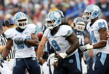 EAST HARTFORD, CT - SEPTEMBER 12:  Bruce Carter #54, Marvin Austin #9 and Michael McAdoo #94 of the North Carolinia Tar Heels celebrate a safety that was awarded to the Tar Heels after the Connecticut Huskies were called for holding on September 12, 2009 at Rentschler Field in East Hartford, Connecticut. The Tar Heels defeated the Huskies 12-10.  (Photo by Elsa/Getty Images)