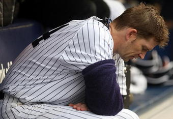 NEW YORK - SEPTEMBER 12:  A.J. Burnett #34 of the New York Yankees sits in the dugout against the Baltimore Orioles on September 12, 2009 at Yankee Stadium in the Bronx borough of New York City.  (Photo by Nick Laham/Getty Images)