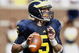 ANN ARBOR, MI - SEPTEMBER 05:  Tate Forcier #5 of the Michigan Wolverines gets ready to throw a second quarter pass while playing the Western Michigan Broncos on September 5, 2009 at Michigan Stadium in Ann Arbor, Michigan.  (Photo by Gregory Shamus/Getty Images)