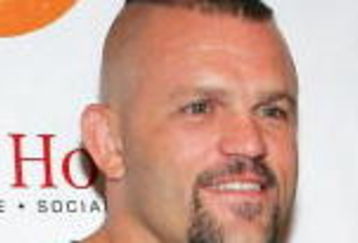 LAS VEGAS - OCTOBER 6:  UFC light heavyweight champion Chuck Liddell (L) and model Jasmine Fiore arrive at the Tangerine Lounge & Nightclub at the Treasure Island Hotel & Casino during the club's two-year anniversary party and the grand opening of the Social House restaurant October 6, 2006 in Las Vegas, Nevada.  (Photo by Ethan Miller/Getty Images)