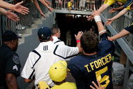 ANN ARBOR, MI - SEPTEMBER 12:  Quarterback Tate Forcier #5 and Michigan head coach Rich Rodriguez give high-fives as they leave the field after beating Notre Dame 38-34 at Michigan Stadium on September 12, 2009 in Ann Arbor, Michigan.  (Photo by Domenic Centofanti/Getty Images)