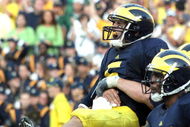 ANN ARBOR, MI - SEPTEMBER 12:  Quarterback Tate Forcier #5 of Michigan is hugged by a teammate after scoring a touchdown late in the game against Notre Dame at Michigan Stadium on September 12, 2009 in Ann Arbor, Michigan.  (Photo by Domenic Centofanti/Getty Images)