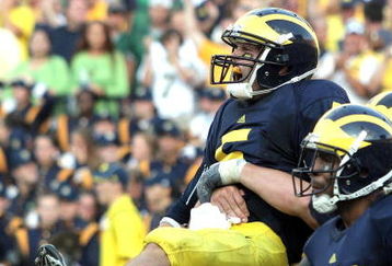 ANN ARBOR, MI - SEPTEMBER 12:  Quarterback Tate Forcier #5 of Michigan is hugged by a teammate after scoring a touchdown late in the game against Notre Dame at Michigan Stadium on September 12, 2009 in Ann Arbor, Michigan.  (Photo by Domenic Centofanti/Getty Images)