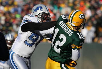 GREEN BAY, WI - DECEMBER 28: Aaron Rodgers #12 of the Green Bay Packers is hit by Dewayne White #99 of the Detroit Lions on December 28, 2008 at Lambeau Field in Green Bay, Wisconsin. The Packers defeated the Lions 31-21. (Photo by Jonathan Daniel/Getty Images)