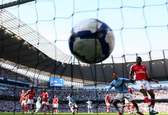 MANCHESTER, ENGLAND - SEPTEMBER 12:  Joleon Lescott (2nd R) of Manchester City watches team-mate Micah Richards' header hit the back of the net during the Barclays Premier League match between Manchester City and Arsenal at the City of Manchester Stadium on September 12, 2009 in Manchester, England.  (Photo by Shaun Botterill/Getty Images)