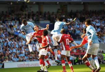 MANCHESTER, ENGLAND - SEPTEMBER 12:   Micah Richards of Manchester City heads the ball goalwards which leads to Manuel Almunia of Arsenal scoring an own goalduring the Barclays Premier League match between Manchester City and Arsenal at the City of Manchester Stadium on September 12, 2009 in Manchester, England. (Photo by Shaun Botterill/Getty Images)