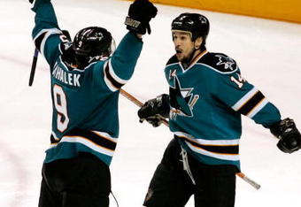 SAN JOSE, CA - MAY 02:  Jonathan Cheechoo #14 of the San Jose Sharks celebrates with teammate Milan Michalek #9 after Michalek scored a third period goal against the Dallas Stars during game five of the Western Conference Semifinals of the 2008 NHL Stanley Cup Playoffs at HP Pavilion on May 2, 2008 in San Jose, California.  (Photo by Christian Petersen/Getty Images)