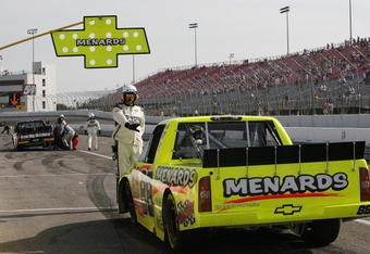 MADISON, IL - SEPTEMBER 12: Matt Crafton, driver of the #88 Menards/NIBCO Chevrolet is held in the pits by officials after being black flag during the Camping World truck race Copart 200 at the Gateway International Raceway September 12, 2009 in Madison, Illinois. (Photo by John Sommers II/Getty Images)