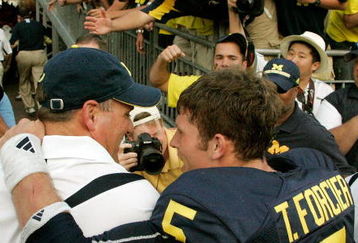 ANN ARBOR, MI - SEPTEMBER 12:  Quarterback Tate Forcier #5 embraces head coach Rich Rodriguez as they approach the tunnel after beating Notre Dame 38-34 at Michigan Stadium on September 12, 2009 in Ann Arbor, Michigan.  (Photo by Domenic Centofanti/Getty Images)