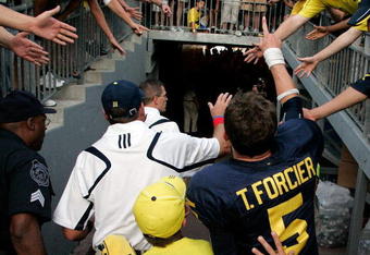 ANN ARBOR, MI - SEPTEMBER 12:  Quarterback Tate Forcier #5 and Michigan head coach Rich Rodriguez give high-fives as they leave the field after beating Notre Dame 38-34 at Michigan Stadium on September 12, 2009 in Ann Arbor, Michigan.  (Photo by Domenic Centofanti/Getty Images)