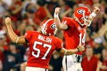 ATHENS, GA - SEPTEMBER 12:  Quarterback Joe Cox #14 and Blair Walsh #57 celebrate a touchdown against the Georgia Bulldogs of the South Carolina Gamecocks at Sanford Stadium on September 12, 2009 in Athens, Georgia.  (Photo by Kevin C. Cox/Getty Images)