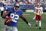 EAST RUTHERFORD, NJ - SEPTEMBER 13:  Mario Manningham #82 of the New York Giants runs in a second quarter touchdown against the Washington Redskins on September 13, 2009 at Giants Stadium in East Rutherford, New Jersey.  (Photo by Jim McIsaac/Getty Images)