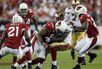 GLENDALE, AZ - NOVEMBER 10:  Josh Morgan #84 of the San Francisco 49ers takes a hit from Karlos Dansby #58 the Arizona Cardinals during the game at University of Phoenix Stadium on November, 10 2008 in Glendale, Arizona.  (Photo by Harry How/Getty Images)