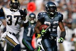 SEATTLE - SEPTEMBER 13:  Running back Julius Jones #22 of the Seattle Seahawks rushes for a touchdown in the third quarter against James Butler #37 of the St. Louis Rams on September 13, 2009 at Qwest Field in Seattle, Washington. The Seahawks defeated the Rams 28-0. (Photo by Otto Greule Jr/Getty Images)