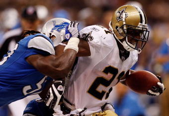 NEW ORLEANS - SEPTEMBER 13:  Mike Bell #21 of the New Orleans Saints is pushed out of bounds by Larry Foote #55 of the Detroit Lions at the Louisiana Superdome on September 13, 2009 in New Orleans, Louisiana.  (Photo by Chris Graythen/Getty Images)