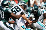 CHARLOTTE, NC - SEPTEMBER 13:  Quarterback Jake Delhomme #17 of the Carolina Panthers is sacked by Linebacker Jordan Akeem #56, of the Philadelphia Eagles in the first half of the NFL season opener at Bank of America Stadium on September 13, 2009 in Charlotte, North Carolina.  (Photo by Streeter Lecka/Getty Images)