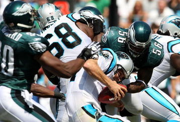 CHARLOTTE, NC - SEPTEMBER 13:  Quarterback Jake Delhomme #17 of the Carolina Panthers is sacked by Linebacker Jordan Akeem #56, of the Philadelphia Eagles in the first half of the NFL season opener at Bank of America Stadium on September 13, 2009 in Charlotte, North Carolina.  (Photo by Streeter Lecka/Getty Images)