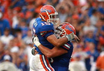 GAINESVILLE, FL - SEPTEMBER 08: Quarterback Tim Tebow #15 and lineman Jim Tartt #63 of the Florida Gators celebrate after Tebow threw a touchdown pass to tight end Cornelius Ingram #7 in the second quarter against the Troy Trojans at Ben Hill Griffin Stadium on September 8, 2007 in Gainesville, Florida.  (Photo by Doug Benc/Getty Images)