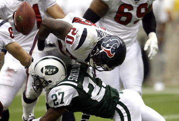 HOUSTON - SEPTEMBER 13: Running back Steve Slaton #20 of the Houston Texans fumbles the ball as he is hit by cornerback Donald Strickland #27 of the New York Jets at Reliant Stadium on September 13, 2009 in Houston, Texas.  (Photo by Bob Levey/Getty Images)