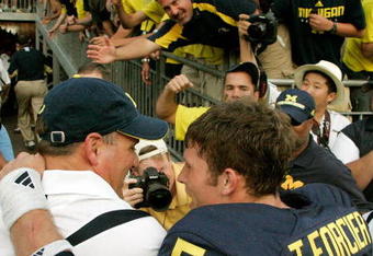 ANN ARBOR, MI - SEPTEMBER 12:  Quarterback Tate Forcier #5 embraces head coach Rich Rodriguez as they approach the tunnel after beating Notre Dame 38-34 at Michigan Stadium on September 12, 2009 in Ann Arbor, Michigan.  (Photo by Domenic Centofanti/Getty Images)