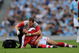 MANCHESTER, ENGLAND - SEPTEMBER 12:  Robin van Persie of Arsenal receives treatment after a challenge from Emmanuel Adebayor of Manchester City during the Barclays Premier League match between Manchester City and Arsenal at the City of Manchester Stadium on September 12, 2009 in Manchester, England.  (Photo by Shaun Botterill/Getty Images)