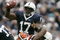 STATE COLLEGE, PA - SEPTEMBER 12: Quarterback Daryll Clark #17 of the Penn State Nittany Lions eludes a tackle by Nico Scott #28 of the Syracuse Orangemen as guard Matt Stankiewitch #54 of the Nittany Lions defends during the first half at Beaver Stadium September 12, 2009 in State College, Pennsylvania. (Photo by Chris Gardner/Getty Images)
