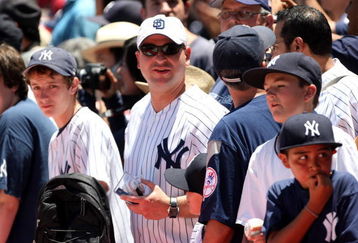 ANAHEIM, CA - JULY 11:  Yankee fans gather over the New York Yankees dugout before thte game with the Los Angeles Angels of Anaheim on July 11, 2009 at Angel Stadium in Anaheim, California.  (Photo by Stephen Dunn/Getty Images)