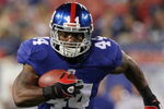 EAST RUTHERFORD, NJ - AUGUST 17:  Ahmad Bradshaw #44 of the New York Giants runs with ball enroute to a touchdown in the first quarter against the Carolina Panthers during the preseason NFL game at Giants Stadium on August 17, 2009 in East Rutherford, New Jersey. (Photo by Jim McIsaac/Getty Images)
