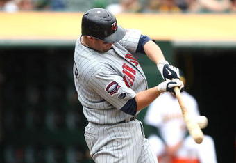 OAKLAND, CA - JUNE 11:  Michael Cuddyer #5 of the Minnesota Twins bats  against the Oakland Athletics during a Major League Baseball game on June 11, 2009 at the Oakland Coliseum in Oakland, California.  (Photo by Jed Jacobsohn/Getty Images)