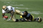 ANN ARBOR, MI - SEPTEMBER 12:  Wide receiver Armando Allen #5 of Notre Dame is tackled by cornerback Donovan Warren #6 of Michigan at Michigan Stadium on September 12, 2009 in Ann Arbor, Michigan.  (Photo by Domenic Centofanti/Getty Images)
