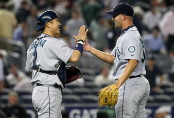 NEW YORK - JULY 02: Kenji Johjima #2 of the Seattle Mariners celebrates the win with pitcher David Aardsma #53 against the New York Yankees on July 2, 2009 at Yankee Stadium in the Bronx borough of New York City.  (Photo by Nick Laham/Getty Images)
