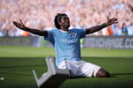 MANCHESTER, ENGLAND - SEPTEMBER 12:  Emmanuel Adebayor of Manchester City celebrates in front of the Arsenal fans after scoring during the Barclays Premier League match between Manchester City and Arsenal at the City of Manchester Stadium on September 12, 2009 in Manchester, England.  (Photo by Shaun Botterill/Getty Images)