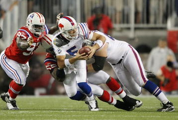 FOXBORO, MA - SEPTEMBER 14:  Jarvis Green #97 and Derrick Burgess #55 of the New England Patriots  sack quarterback Trent Edwards #5 of the Buffalo Bills in the final minute of the game on September 14, 2009 at Gillette Stadium in Foxboro, Massachusetts. The Patriots defeated the Bills 25-24.  (Photo by Elsa/Getty Images)