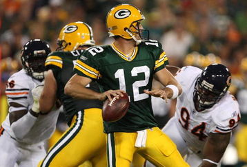 GREEN BAY, WI - SEPTEMBER 13: Aaron Rodgers #12 of the Green Bay Packers looks to pass as Alex Brown #96 and Marcus Harrison #94 of the Chicago Bears rush on September 13, 2009 at Lambeau Field in Green Bay, Wisconsin. (Photo by Jonathan Daniel/Getty Images)