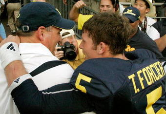 ANN ARBOR, MI - SEPTEMBER 12:  Quarterback Tate Forcier #5 embraces head coach Rich Rodriguez as they approach the tunnel after beating Notre Dame 38-34 at Michigan Stadium on September 12, 2009 in Ann Arbor, Michigan.  (Photo by Domenic Centofanti/Getty Images)