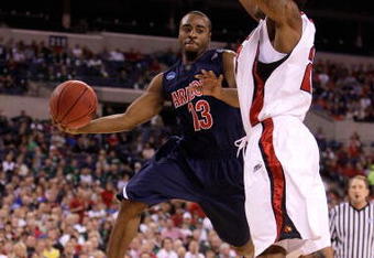 INDIANAPOLIS - MARCH 27:  Nic Wise #13 of the Arizona Wildcats looks to pass the ball as he drives against Terrence Jennings #23 of the Louisville Cardinals  during the third round of the NCAA Division I Men's Basketball Tournament at the Lucas Oil Stadium on March 27, 2009 in Indianapolis, Indiana.  (Photo by Andy Lyons/Getty Images)