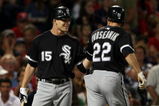 BOSTON - AUGUST 26:  Scott Podsednik #22 of the Chicago White Sox is congratulated by teammate Gordon Beckham #15 fter Podsednik hit a solo home run to tie the game in the 8th inning against the Boston Red Sox on August 26, 2009 at Fenway Park in Boston, Massachusetts.  (Photo by Elsa/Getty Images)