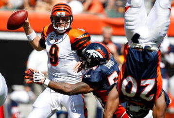 CINCINNATI, OH - SEPTEMBER 13: Quarterback Carson Palmer #9 of the Cincinnati Bengals is sacked by linebacker Andre Davis #54 of the Denver Broncos as defensive back Brian Dawkins #20 flips against the Denver Broncos at Paul Brown Stadium on September 13, 2009 in Cincinnati, Ohio. (Photo by Scott Boehm/Getty Images)