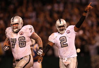 OAKLAND, CA - SEPTEMBER 14:  (L-R) Robert Gallery #76 and JaMarcus Russell #2 of the Oakland Raiders celebrate after Russell threw a 57-yard touchdown pass to Louis Murphy #18 in the fourth quarter against the San Diego Chargers on September 14, 2009 at the Oakland-Alameda County Coliseum in Oakland, California.  (Photo by Ezra Shaw/Getty Images)