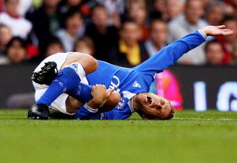 LONDON, ENGLAND - SEPTEMBER 13:  Phil Neville of Everton lies injured during the Barclays Premier League match between Fulham and Everton at Craven Cottage on September 13, 2009 in London, England.  (Photo by Ryan Pierse/Getty Images)