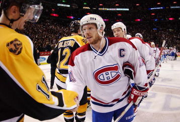 MONTREAL-APRIL 29:  Captain Saku Koivu #11 of the Montreal Canadiens and P.J. Axelsson #11 of the Boston Bruins take part in the traditional handshake following game 6 of their Eastern Conference first round playoff series at the Molson Center in Montreal, Quebec, Canada on April 29, 2002. The Canadiens won 2-1 to win the series four games to two. Photo by Dave Sandford/Getty Images/NHLI