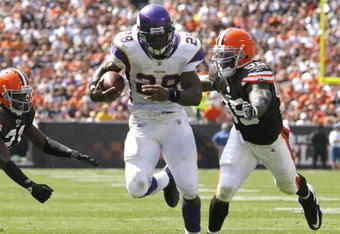 CLEVELAND - SEPTEMBER 13:  Adrian Peterson #28 of the Minnesota Vikings runs by Brodney Pool #21 and Corey Willams #99 of the Cleveland Brwons at Cleveland Browns Stadium on September 13, 2009 in Cleveland, Ohio.  (Photo by Matt Sullivan/Getty Images)
